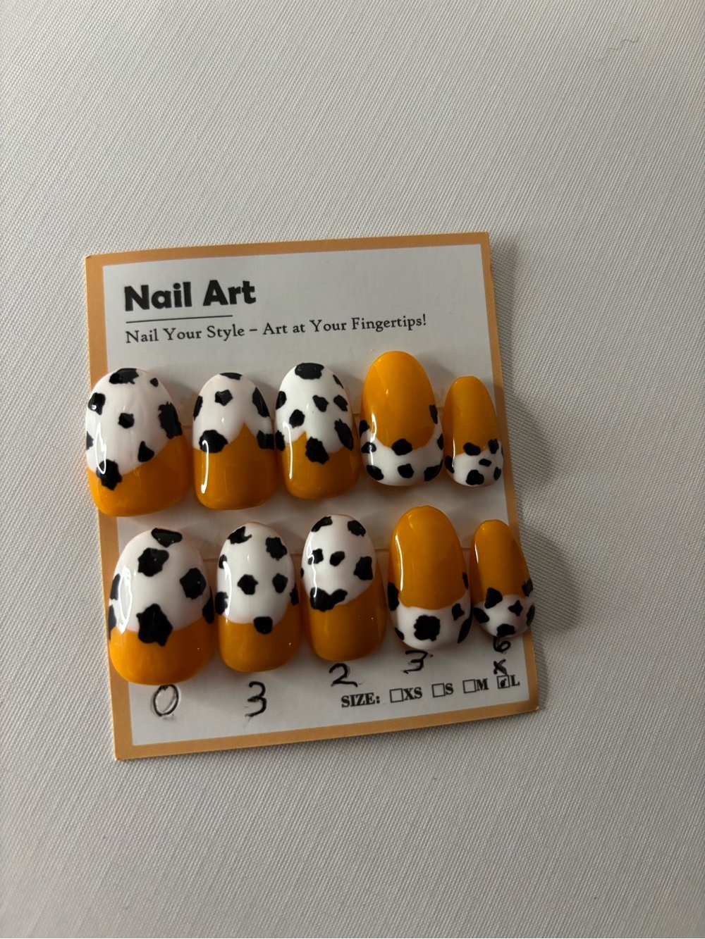 Orange press on nails with cow print